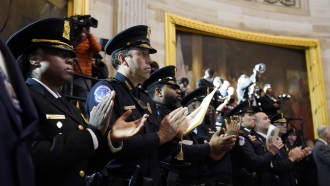 Police officers applaud during a Congressional Gold Medal ceremony.