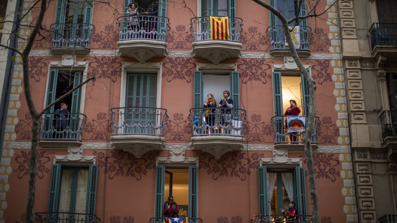 Residents in Barcelona, Spain cheer medical workers from their balconies.