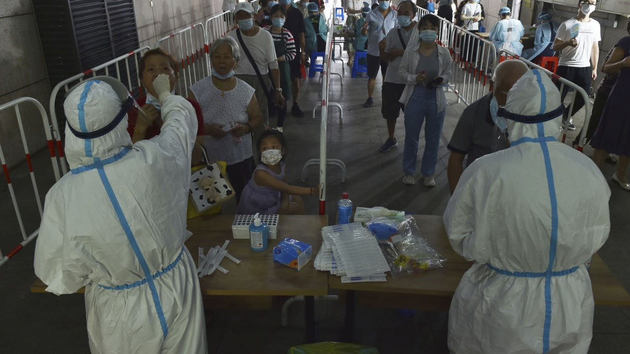 Medical workers takes throat swab samples in new round of COVID-19 testing in Nanjing city.
