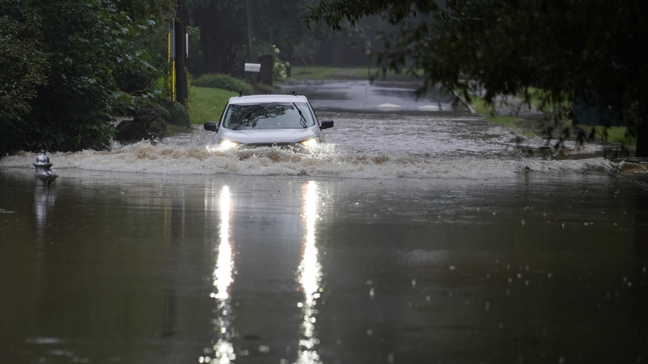 A car attempts to drive through flood waters from Tropical Depression Fred.