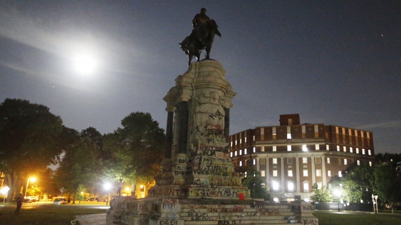 The moon illuminates the statue of Confederate General Robert E. Lee on Monument Avenue