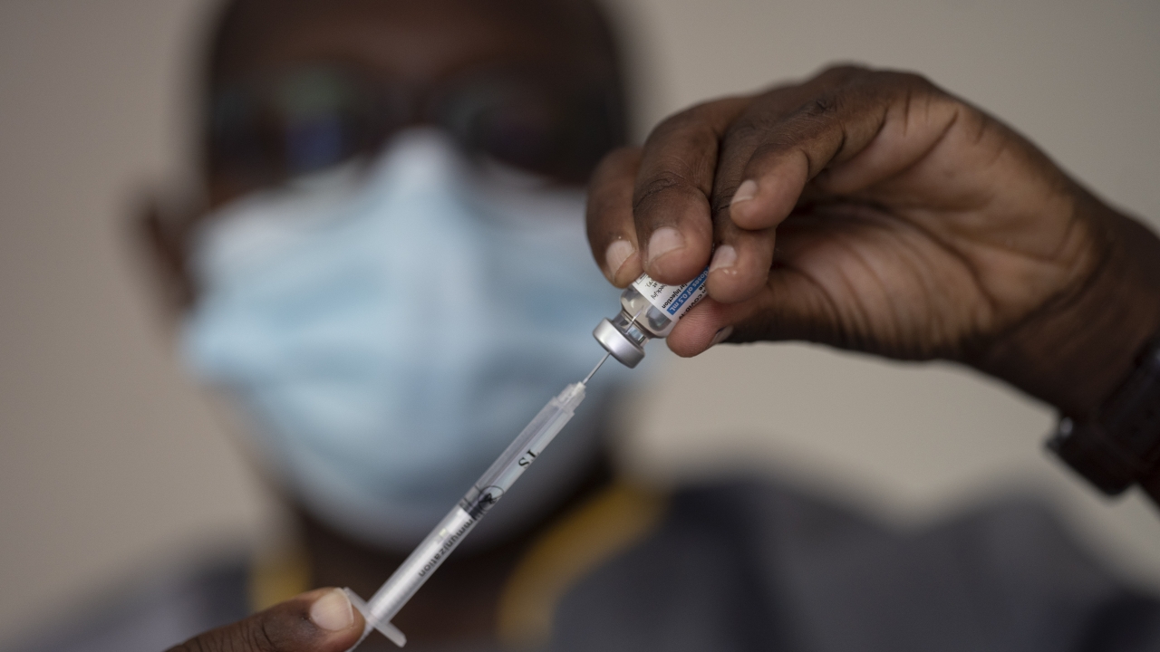 Health worker fills a syringe with a COVID-19 vaccine.