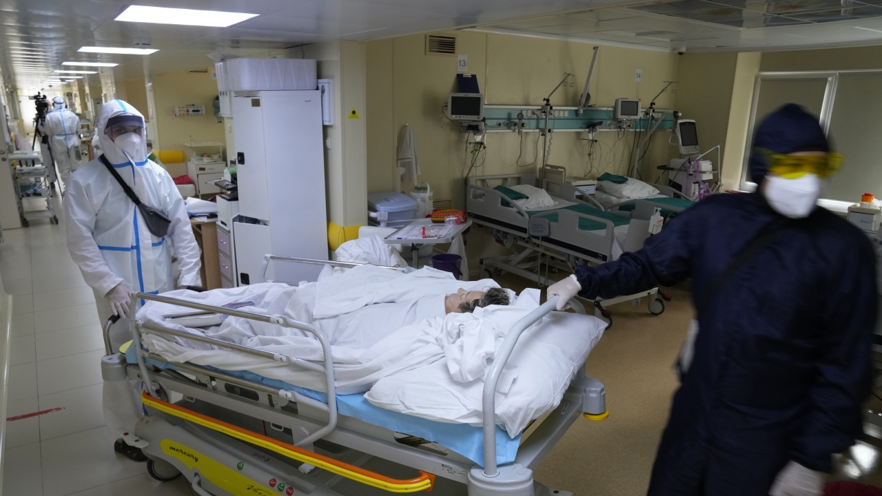 Medical staff members wearing special suits to protect against COVID-19 move a patient with coronavirus at an ICU in Moscow.