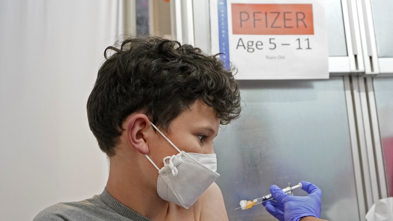 A photo of a boy getting the first dose of Pfizer's COVID vaccine.