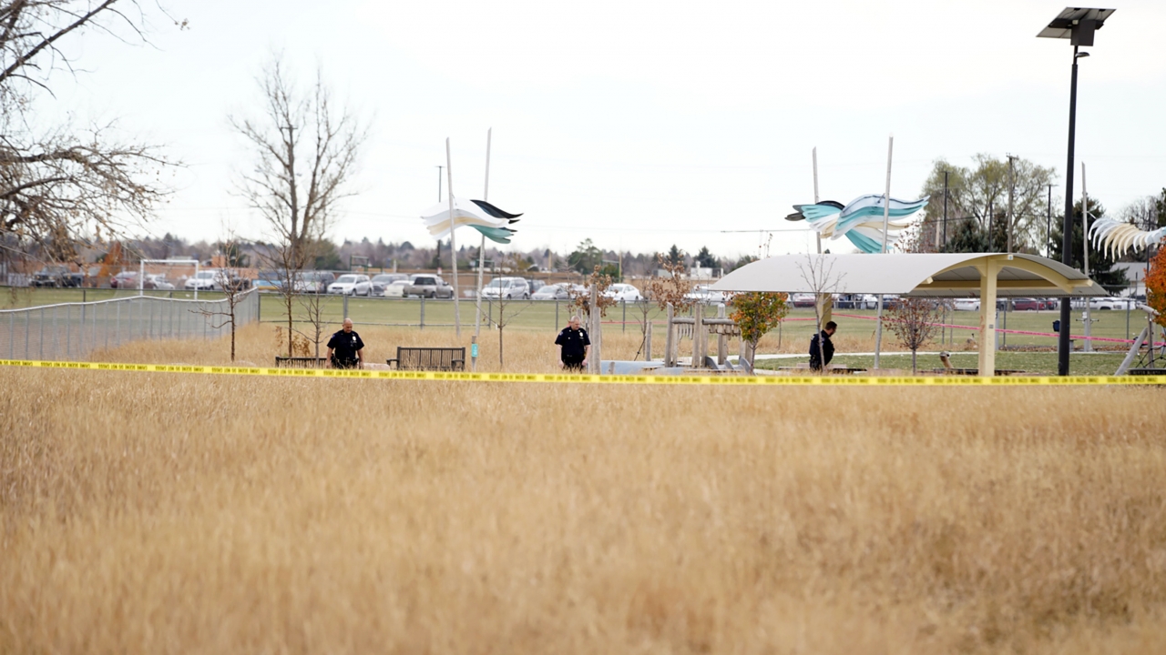 Law enforcement and investigators at a park where a shooting took place near a high school in Aurora, Colo.
