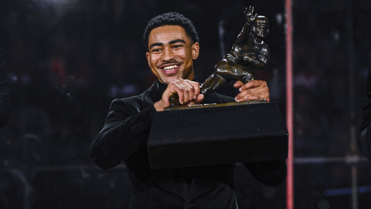 Alabama quarterback Bryce Young holds the Heisman Trophy