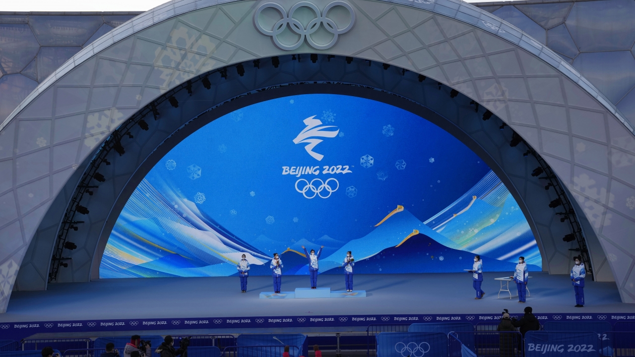 Staff members rehearse a victory ceremony at the Beijing Medals Plaza of the Winter Olympics.