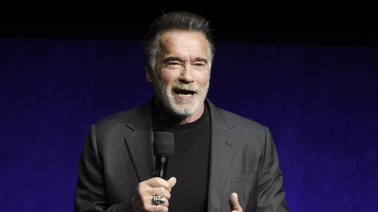 Arnold Schwarzenegger speaking on stage.