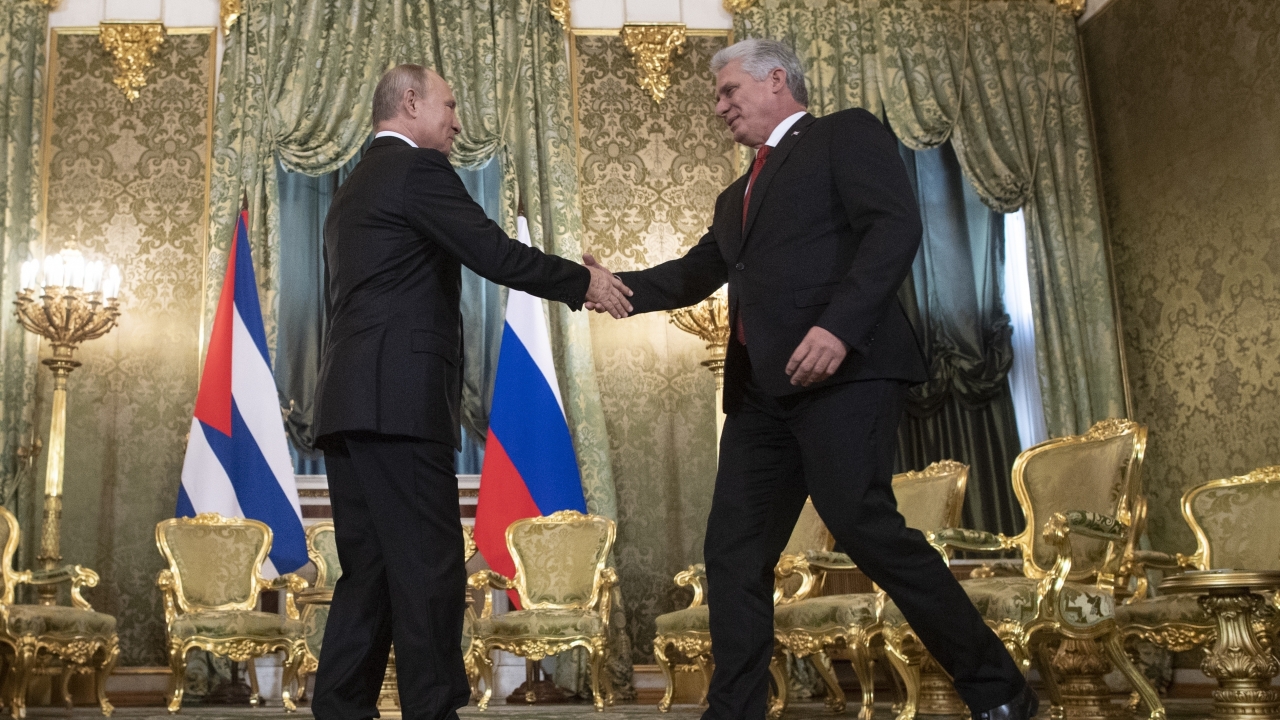 Russian President Vladimir Putin, left, shakes hands with Cuban President Miguel Diaz-Canel.