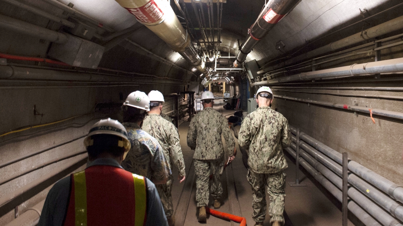Navy and civilian water quality recovery experts through the tunnels of the Red Hill Bulk Fuel Storage Facility.
