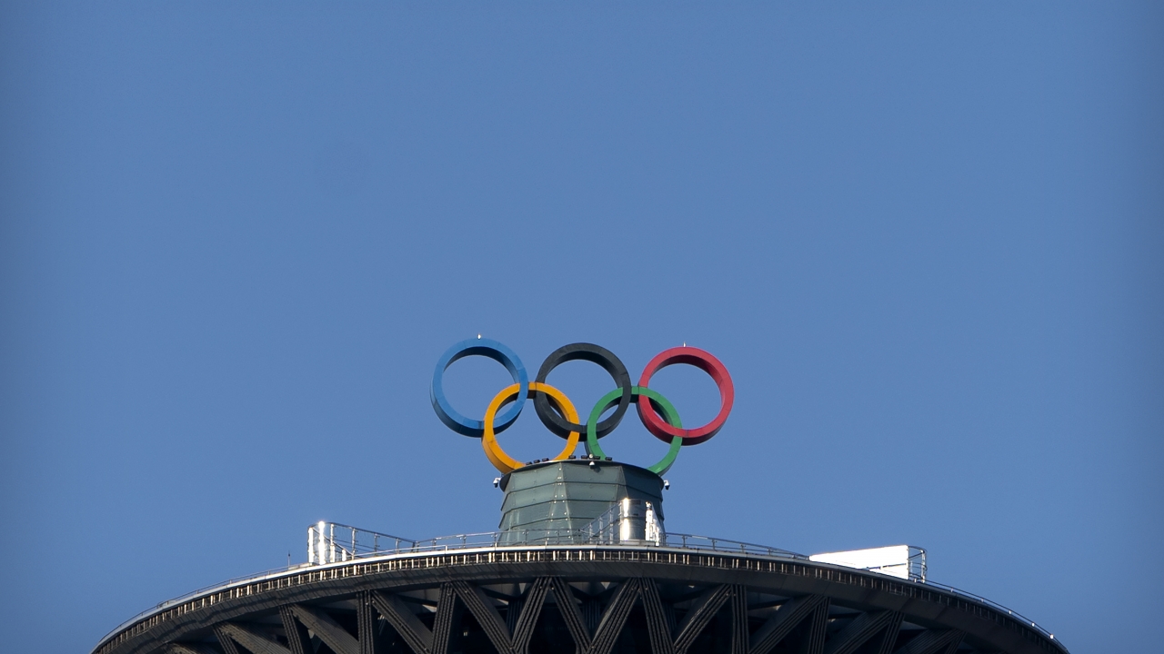 The Olympic rings are visible atop the Olympic Tower.