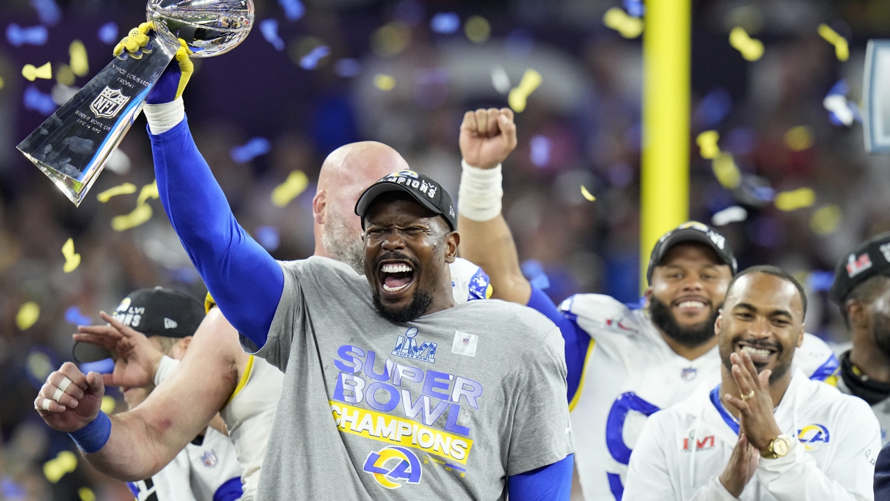 Los Angeles Rams linebacker Von Miller lifts the Lombardi Trophy after winning the Super Bowl