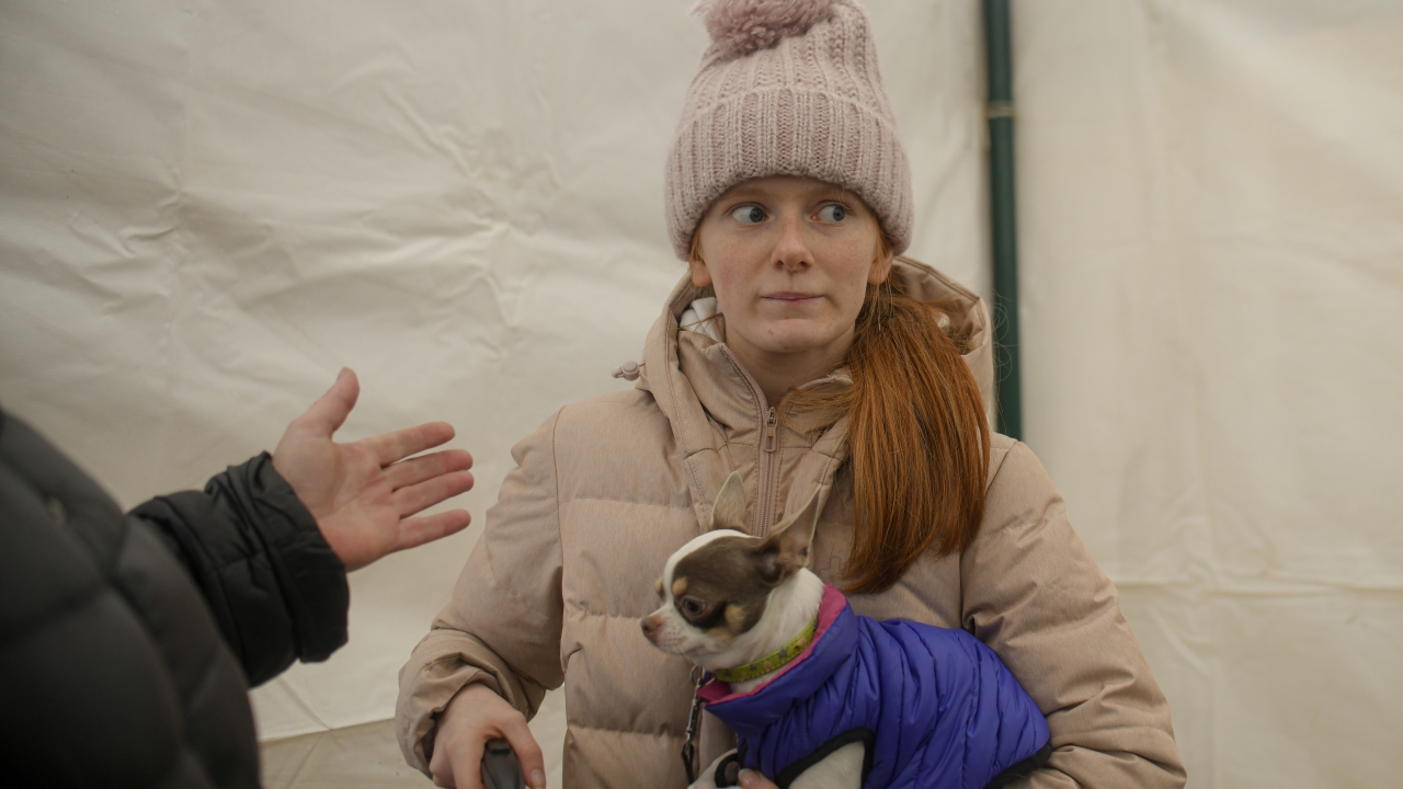 Margot, 15 years-old, refugee fleeing the conflict from neighbouring Ukraine holds her dog inside a tent