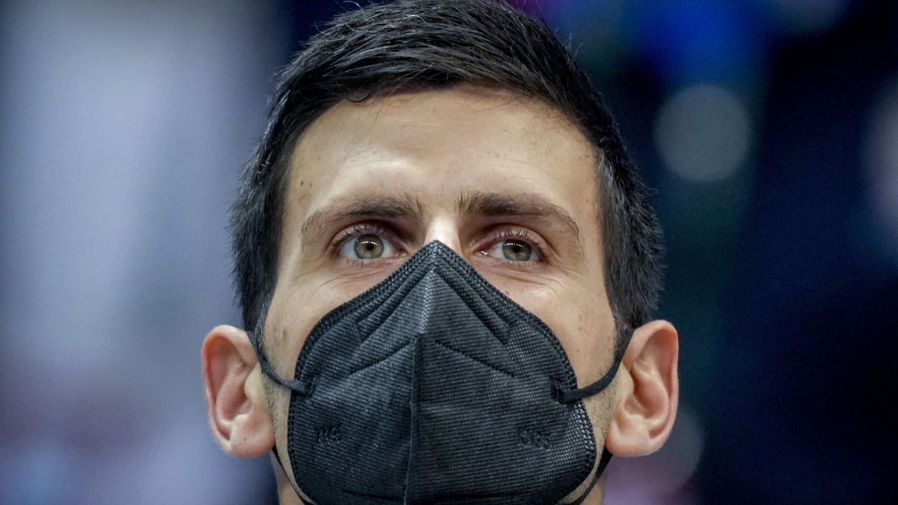 Serbian tennis player Novak Djokovic wears a face mask