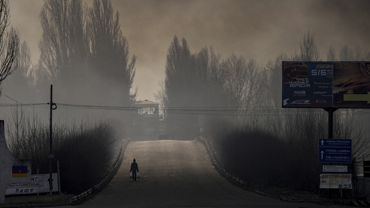 Warehouse destroyed by Russian bombardment casts shadows on the road outside Kyiv, Ukraine.