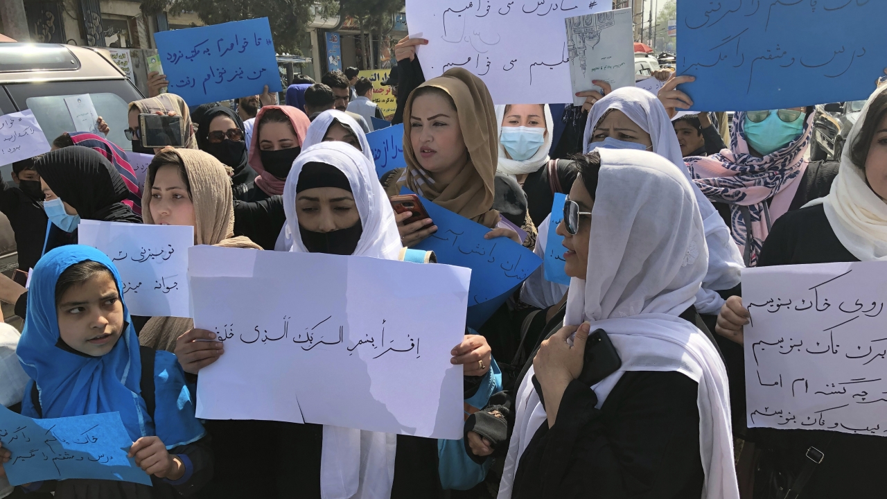 Afghan women chant and hold signs of protest during a demonstration in Kabul, Afghanistan