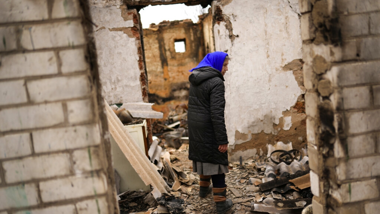 Woman enters her destroyed father's home in the aftermath of the battle.