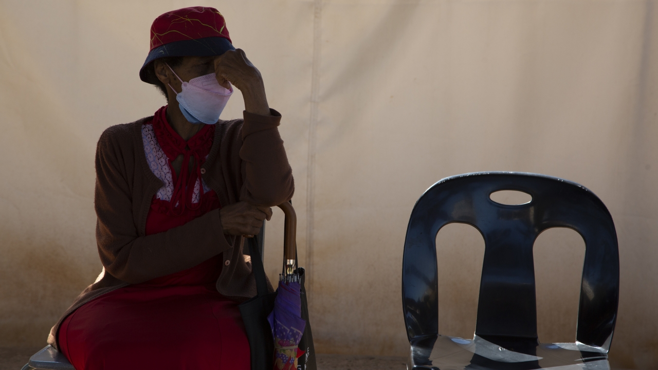 A woman waits in a queue to be screened for COVID-19 at a testing centre in Soweto, South Africa