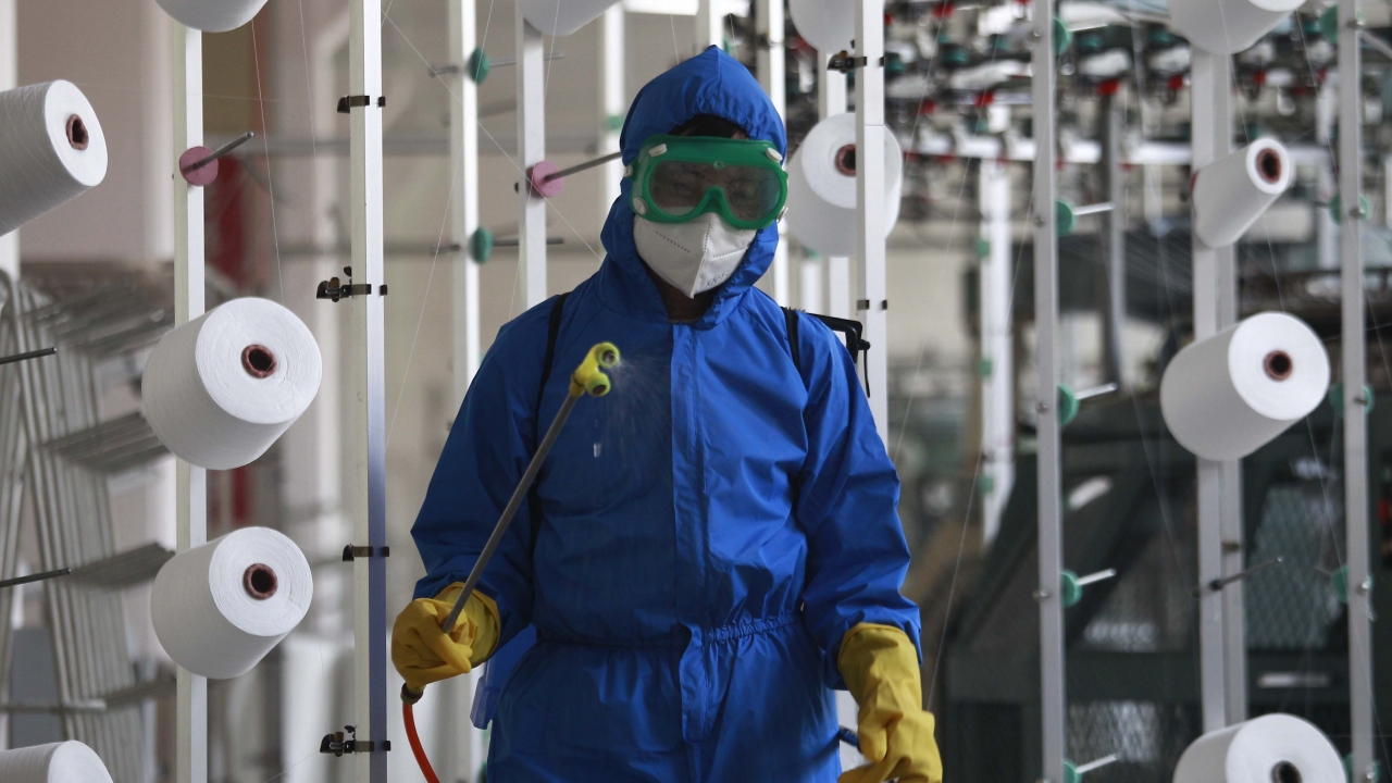 An employee in North Korea disinfects the work floor
