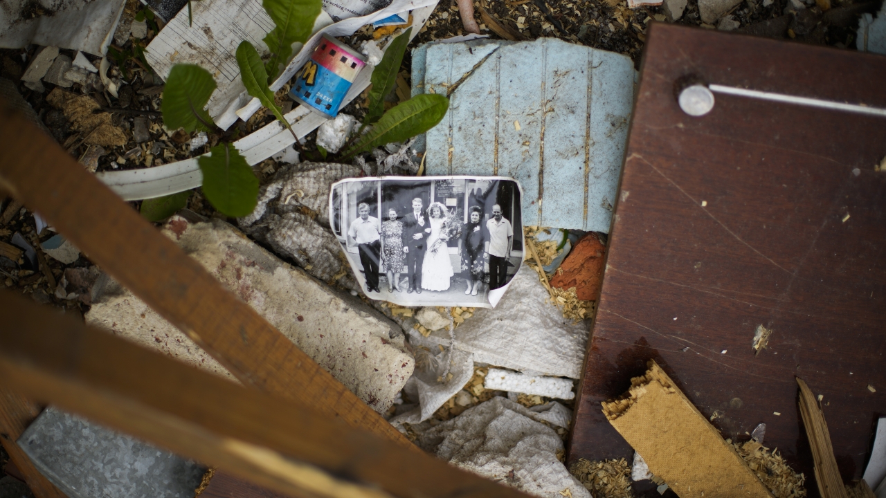 A wedding photograph lies among rubble from a Russian strike