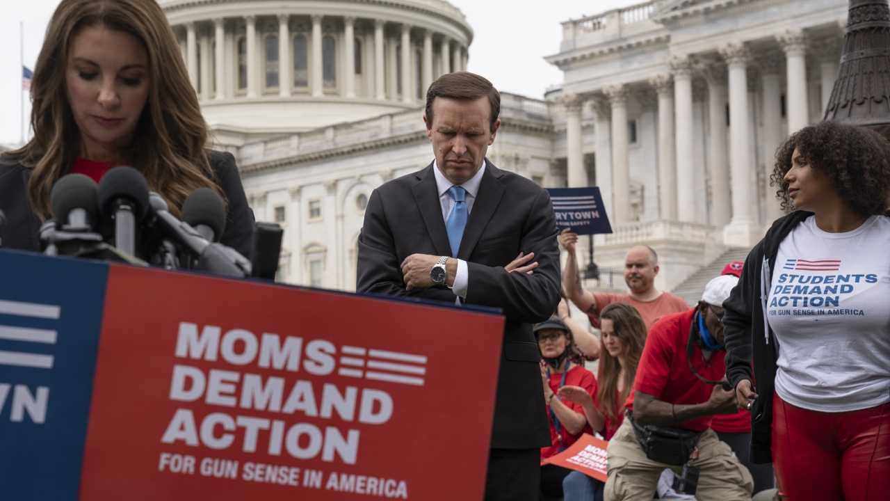 Sen. Chris Murphy stand with activists demanding action on gun control
