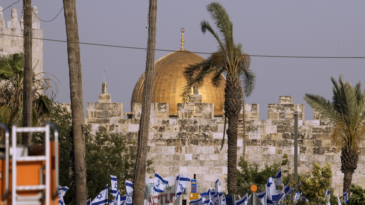 Israelis wave national flags in front of Damascus Gate outside Jerusalem's Old City to mark Jerusalem Day