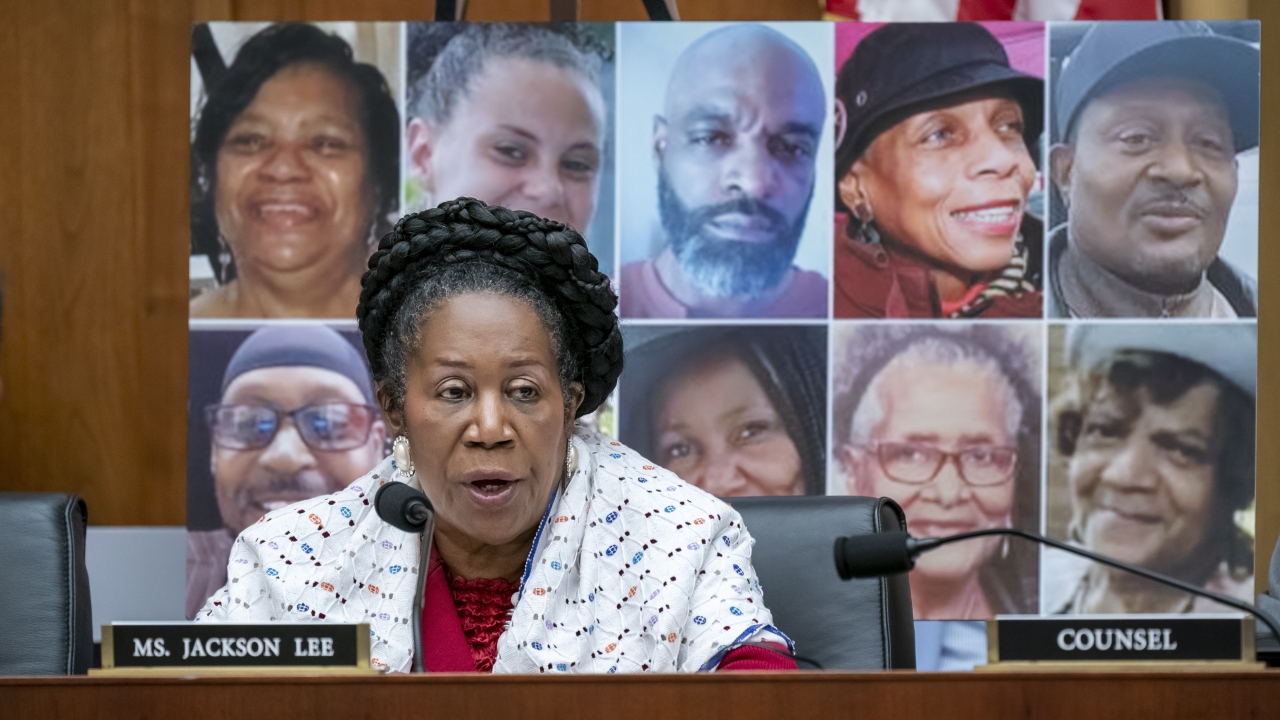 Photos of the victims killed in a Buffalo, N.Y. shooting behind Rep. Sheila Jackson