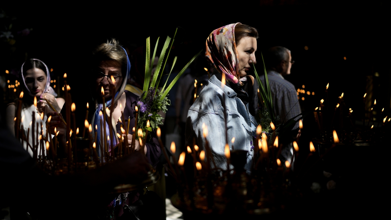 Women attend a mass at St. Volodymyr's Cathedral during Orthodox Pentecost in Kyiv, Ukraine