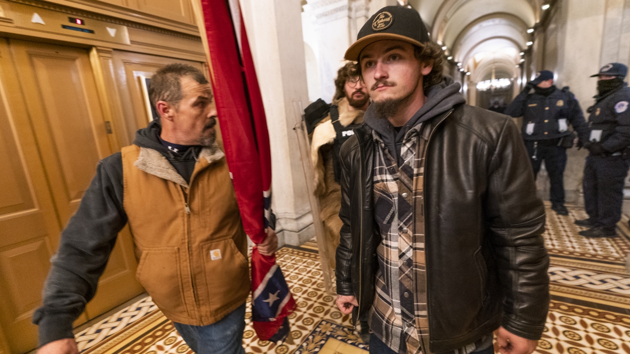 Kevin Seefried carries a Confederate flag inside the U.S. Capitol on Jan. 6, 2021.
