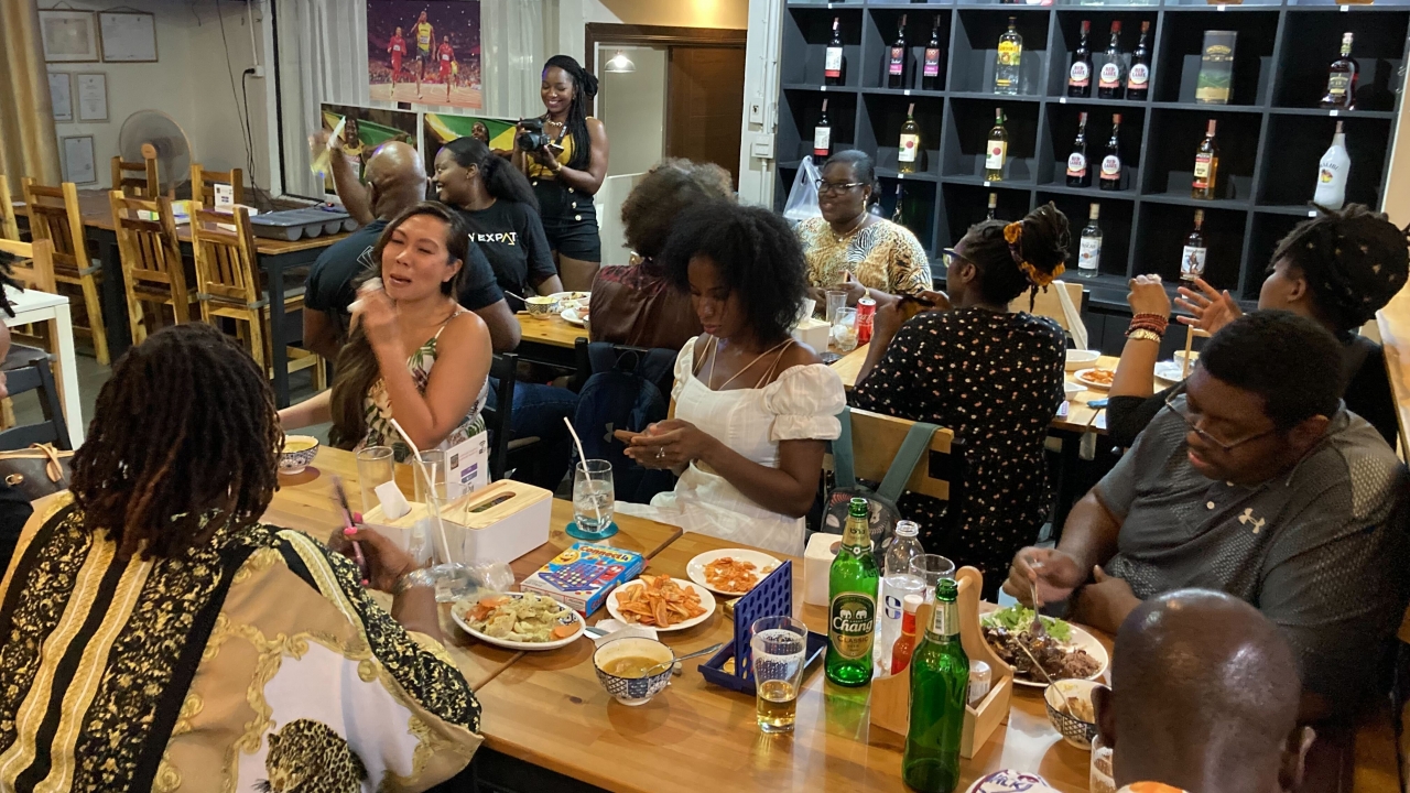 About 20 people of African descent living abroad gather at a Jamaican restaurant in Thailand to celebrate Juneteenth