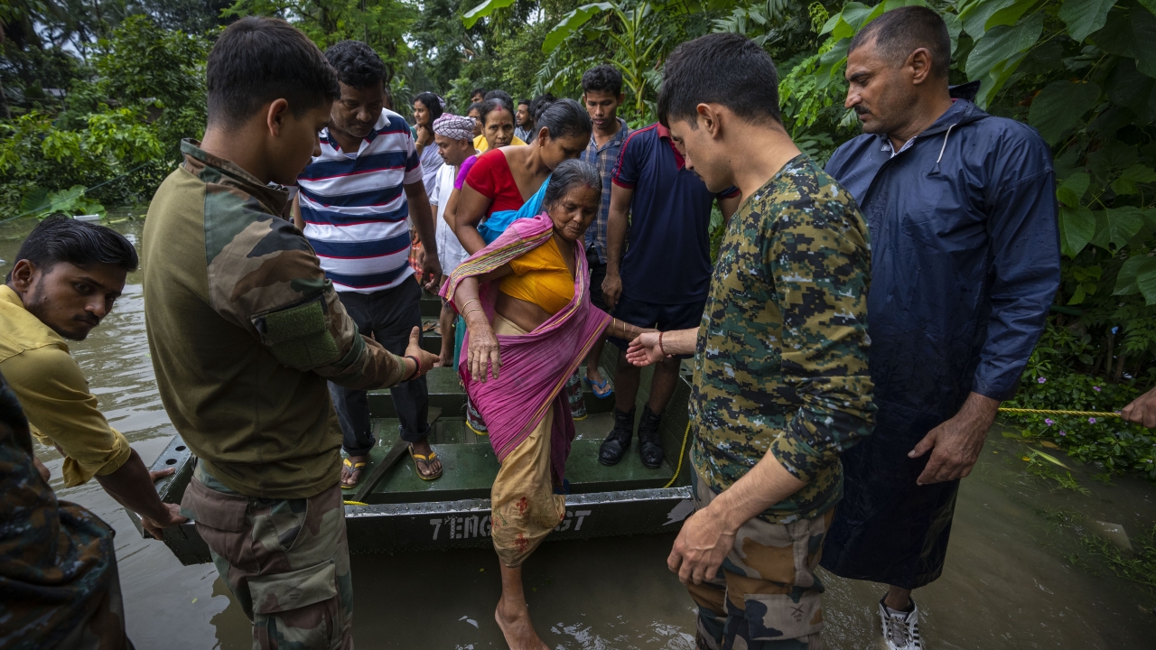 Indian army personnel rescue flood-affected villagers on a boat
