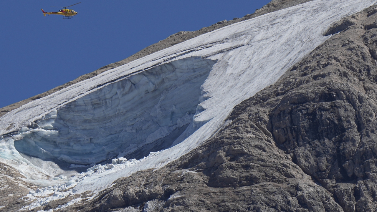 A rescue helicopter hovers over the Punta Rocca glacier near Canazei, in the Italian Alps.