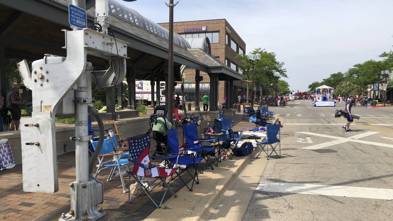 Abandoned chairs sit along the sidewalk after parade-goers fled Highland Park's Fourth of July parade after shots were fired.