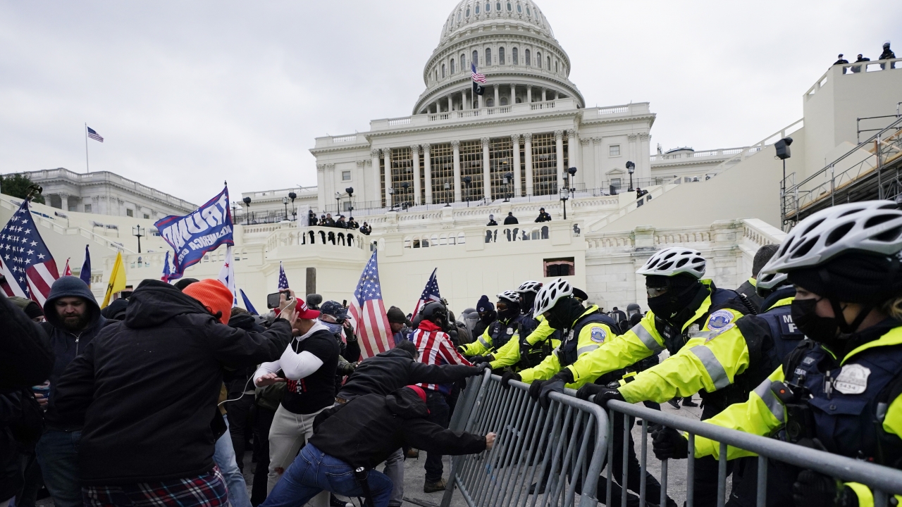 Violent insurrections loyal to President Donald Trump break through a police barrier at the Capitol