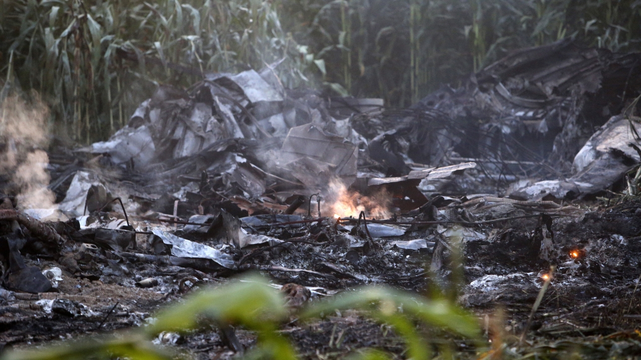 Debris of an Antonov cargo plane smolders in Palaiochori village in northern Greece