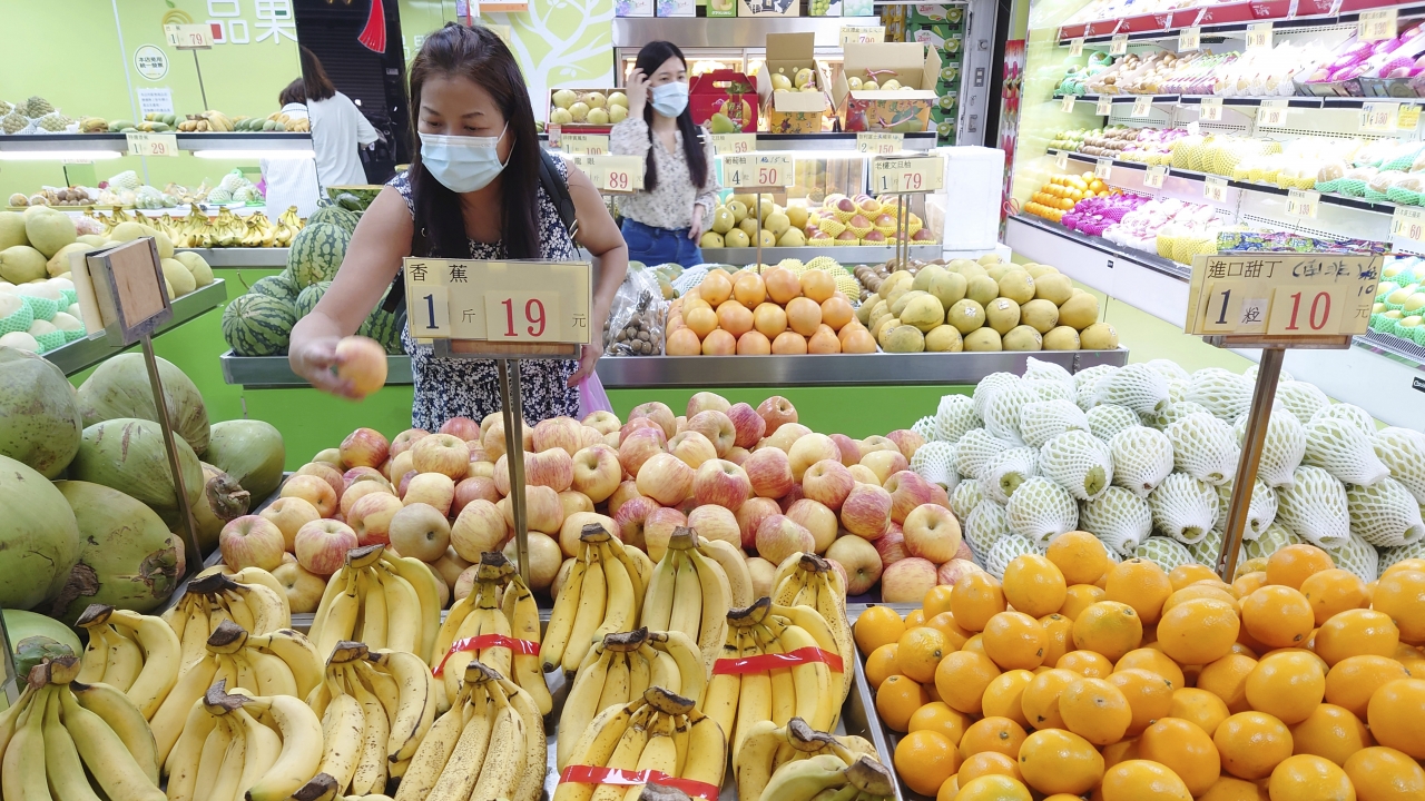 Customers buy fruit at a stall in Taipei, Taiwan.