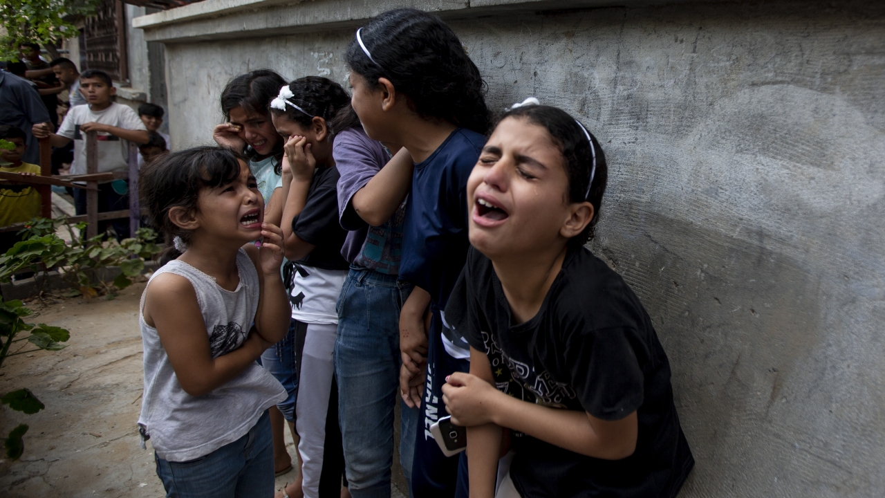 Mourners react during the funeral of Palestinian Tamim Hijazi, who was killed in an Israeli air strike.
