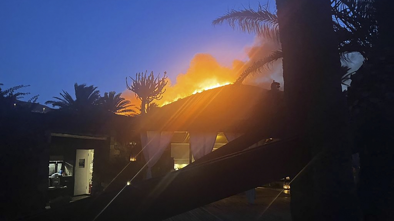 Flames burn beyond fashion designer Giorgio Armani's villa on the Sicilian island of Pantelleria