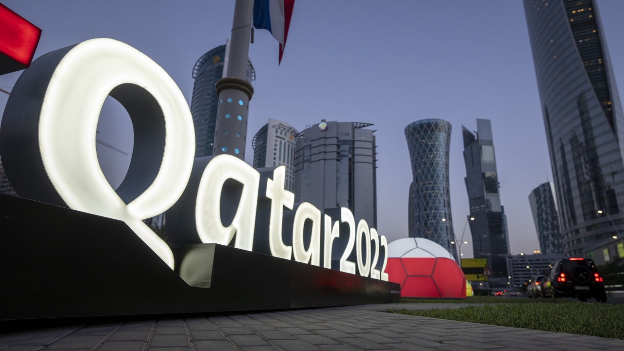 A display reads "Qatar 2022 " near the Doha Exhibition and Convention Center