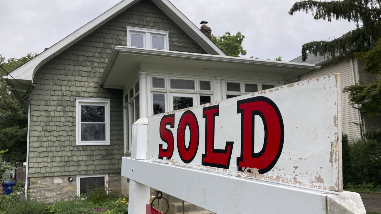 A "sold" sign outside a home.
