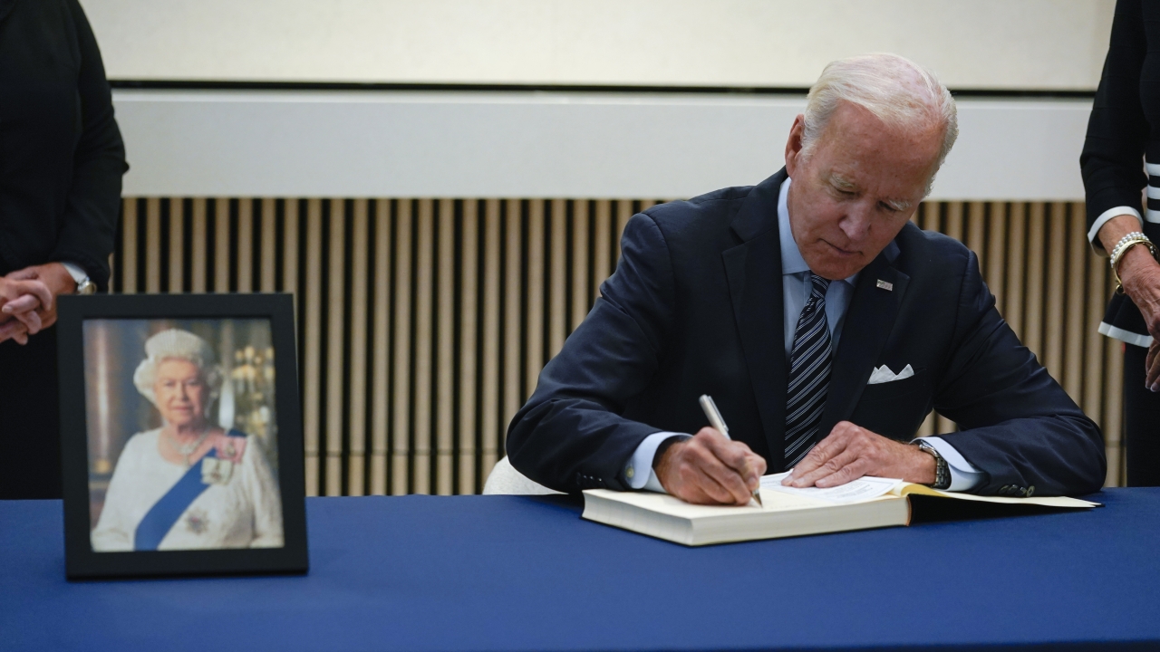 President Joe Biden signs a condolence book at the British Embassy in Washington, D.C.