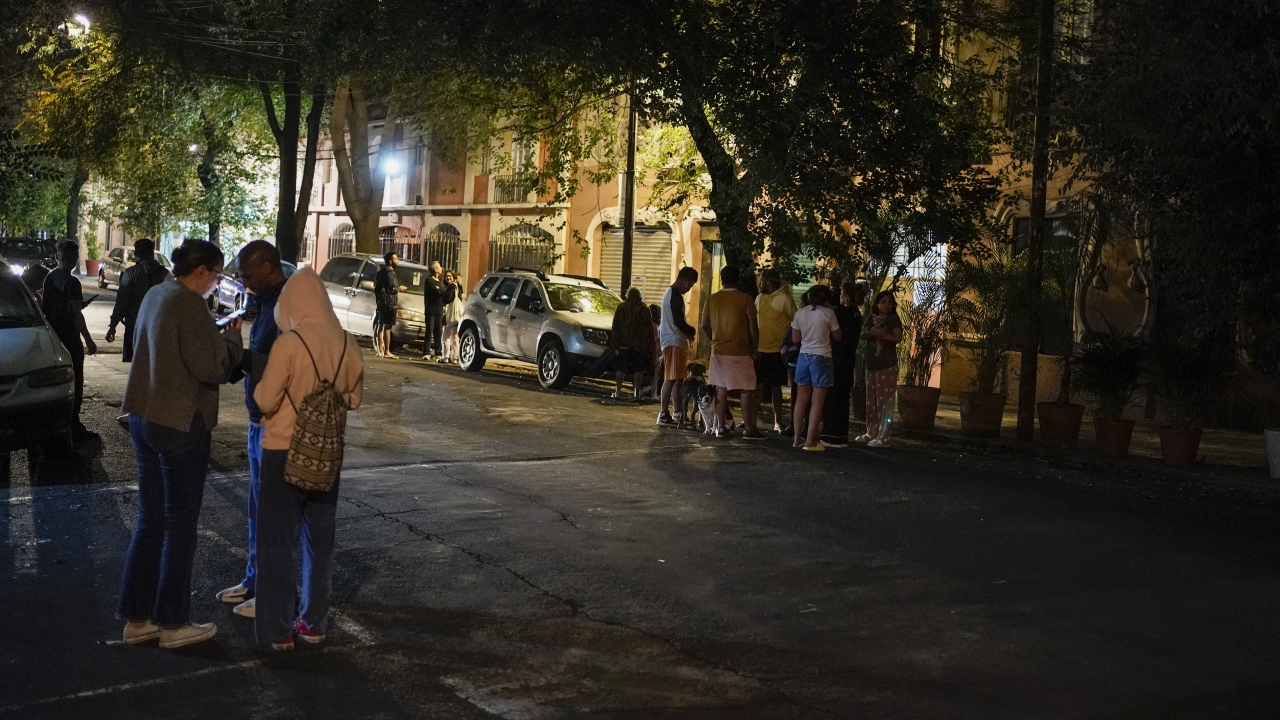 People gather outside after an earthquake was felt in Mexico City