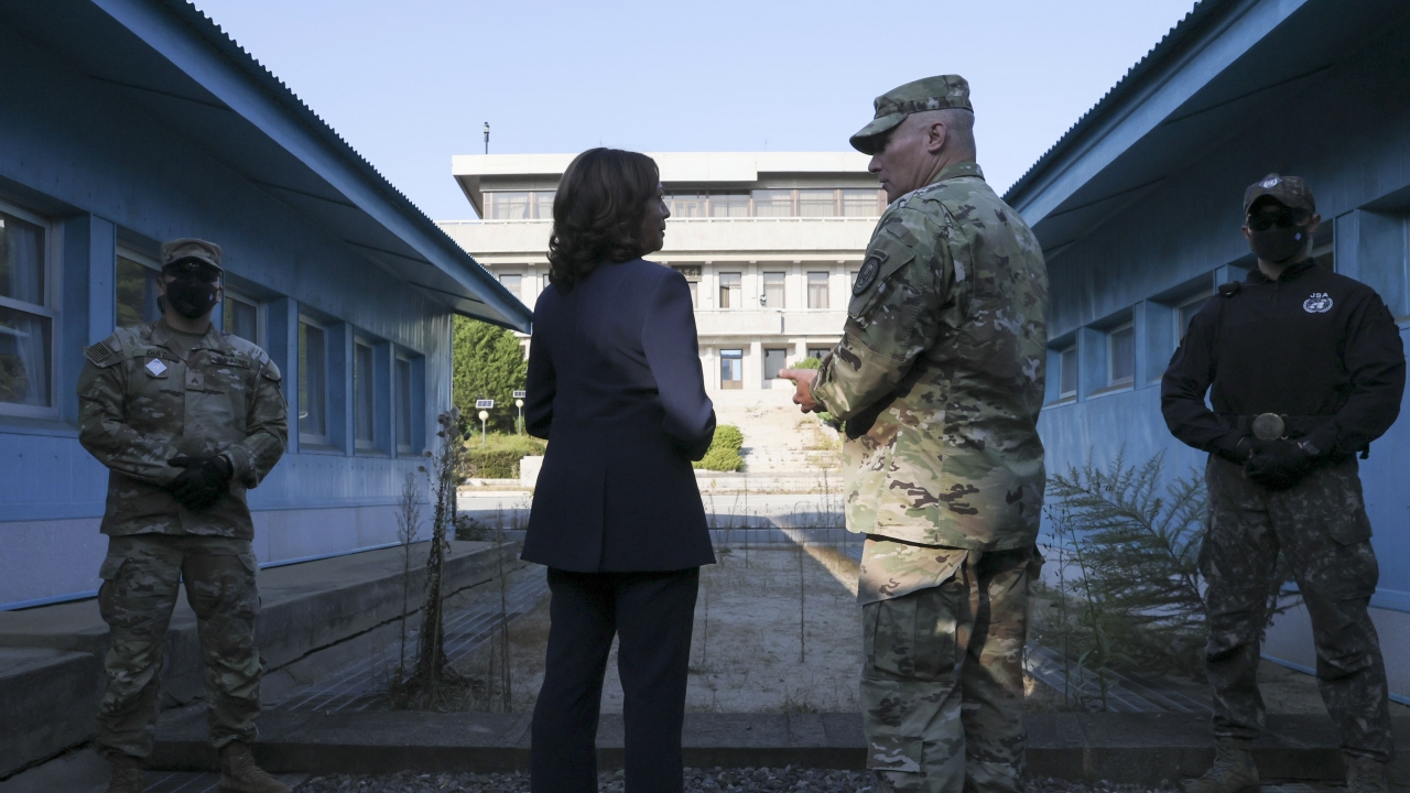 U.S. Vice President Kamala Harris, center left, stands next to the demarcation line at the demilitarized zone