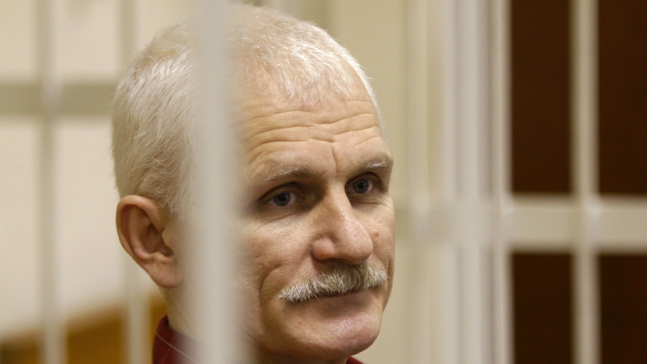 Ales Bialiatski, the head of Belarusian Vyasna rights group, stands in a defendants' cage during a court session.
